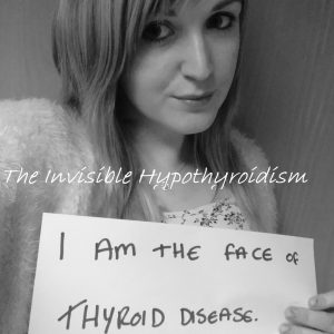 A selfie of Rachel holding a sign reading 'I am the face of Thyroid Disease'