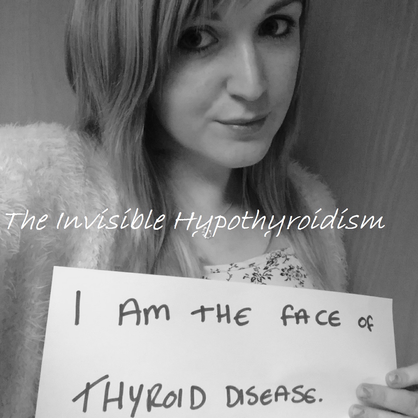 A selfie of Rachel holding a sign reading 'I am the face of Thyroid Disease'