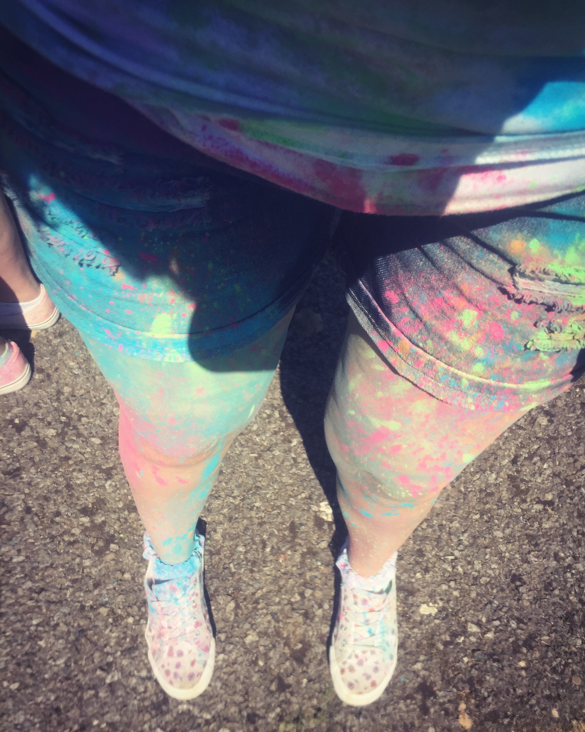 A photo looking for at Rachels legs covered in multicoloured powder