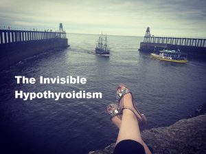 A photo of Rachel's feet dangling over the edge of a wall facing into a harbour. An old wooden ship is pulling in over cloudy skies.