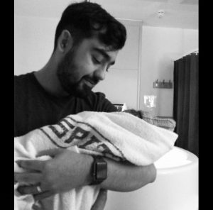 Rachel's Husband Adam Holding Their Baby